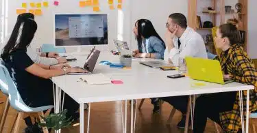 five person by table watching turned on white iMac